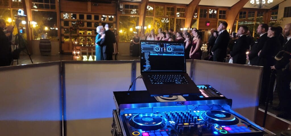Photo of the wedding party after introductions and the groom dancing with his mother.